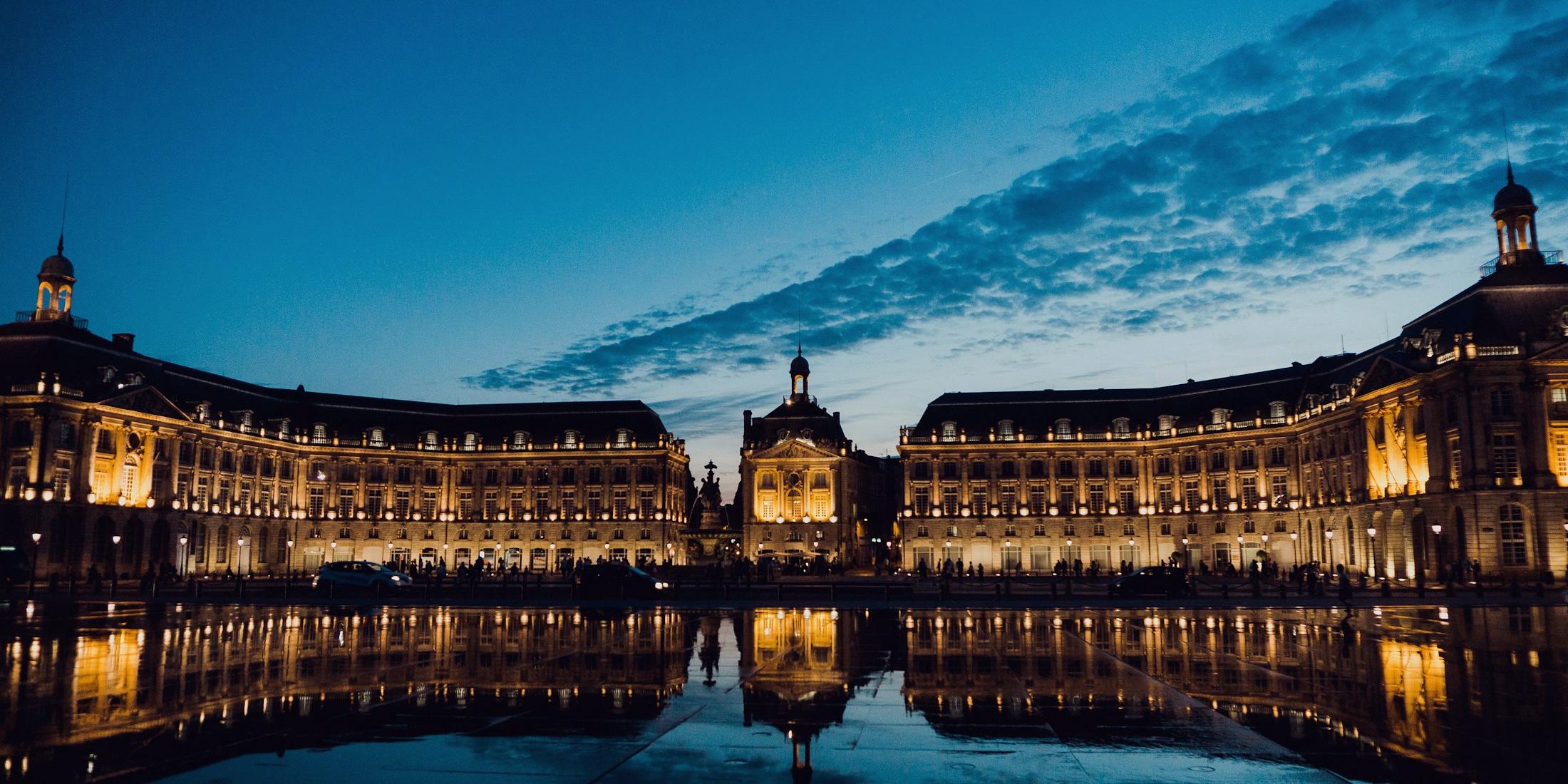 Plaza de la Bolsa de Burdeos reflejada en el espejo de agua de noche